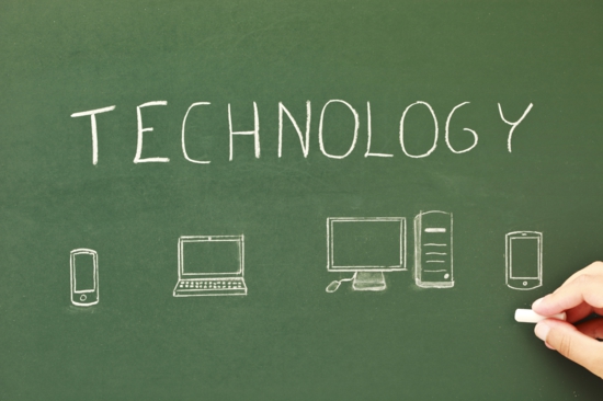 the word technology and computers drawn on a chalkboard