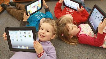 iPads in the classroom, students holding ipads,