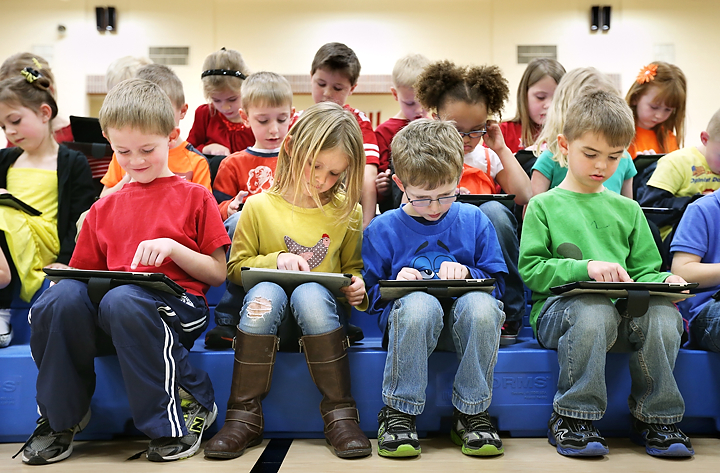 k12 students using tablets for learning in the classroom