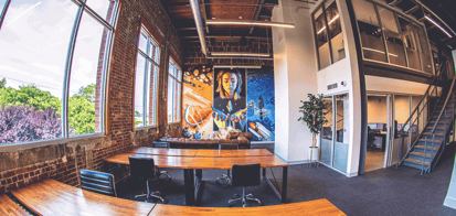 Coworking space with dedicated desks and a unique mural to spark creativity