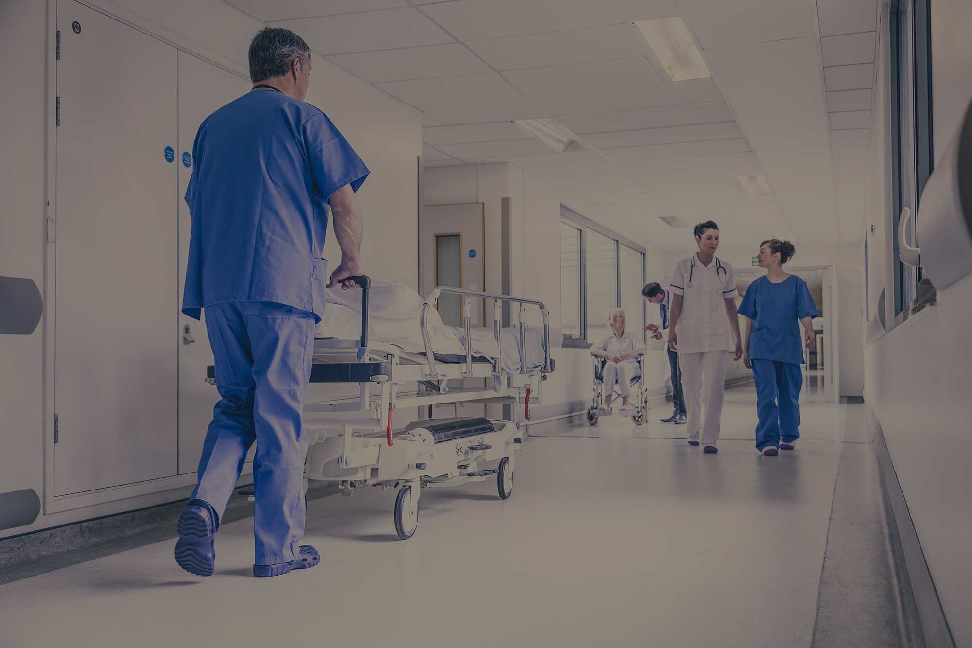 medical professionals walking down hospital hallway